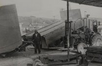 Men loading concrete tank onto truck