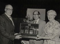 P Collins presenting Andrew and Doreen McLay with cutlery set