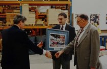 Three men with a painting