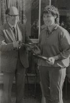 Andrew McLay presenting trophy to netballer