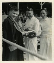 Bill O'Connor adjusting Ross Sadler's boxing gloves in preparation for a fight