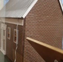 B2023.14.01 Dollhouse - Back with front panel stored in front of back wall