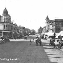 Woman walking in middle of Main St., ca. 1912.