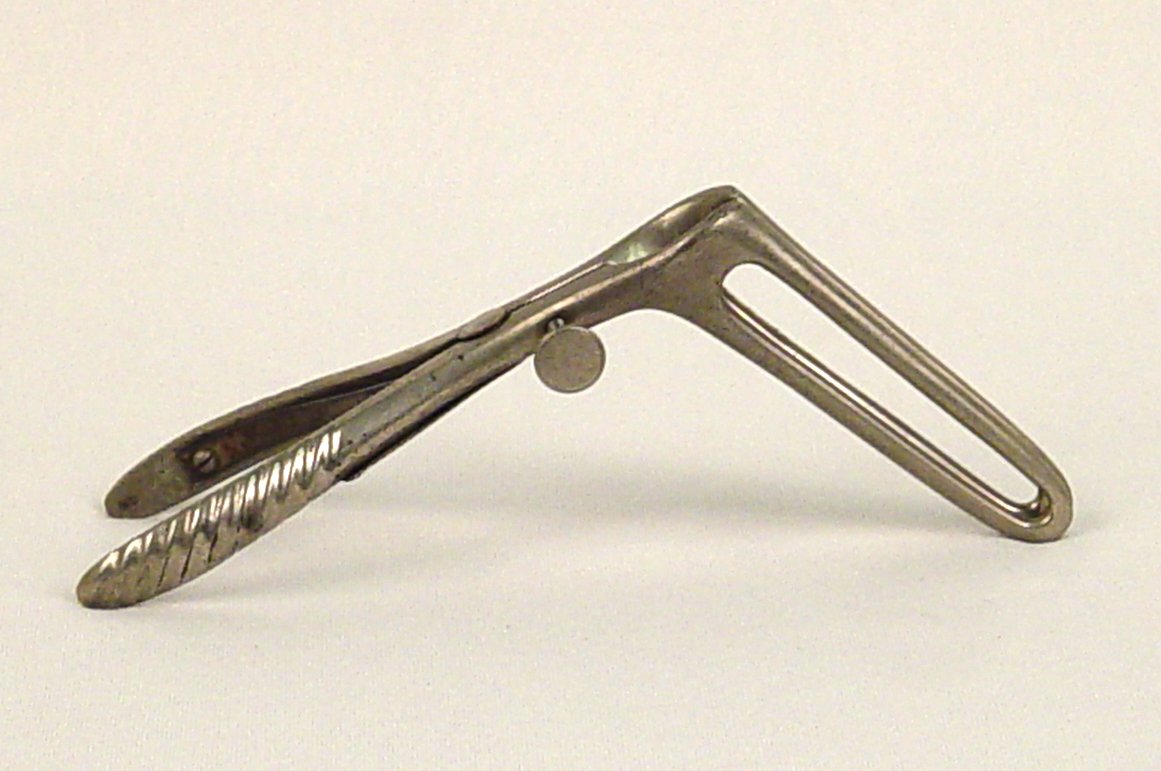Rectal speculum, grey metal with long fenestrated arms.