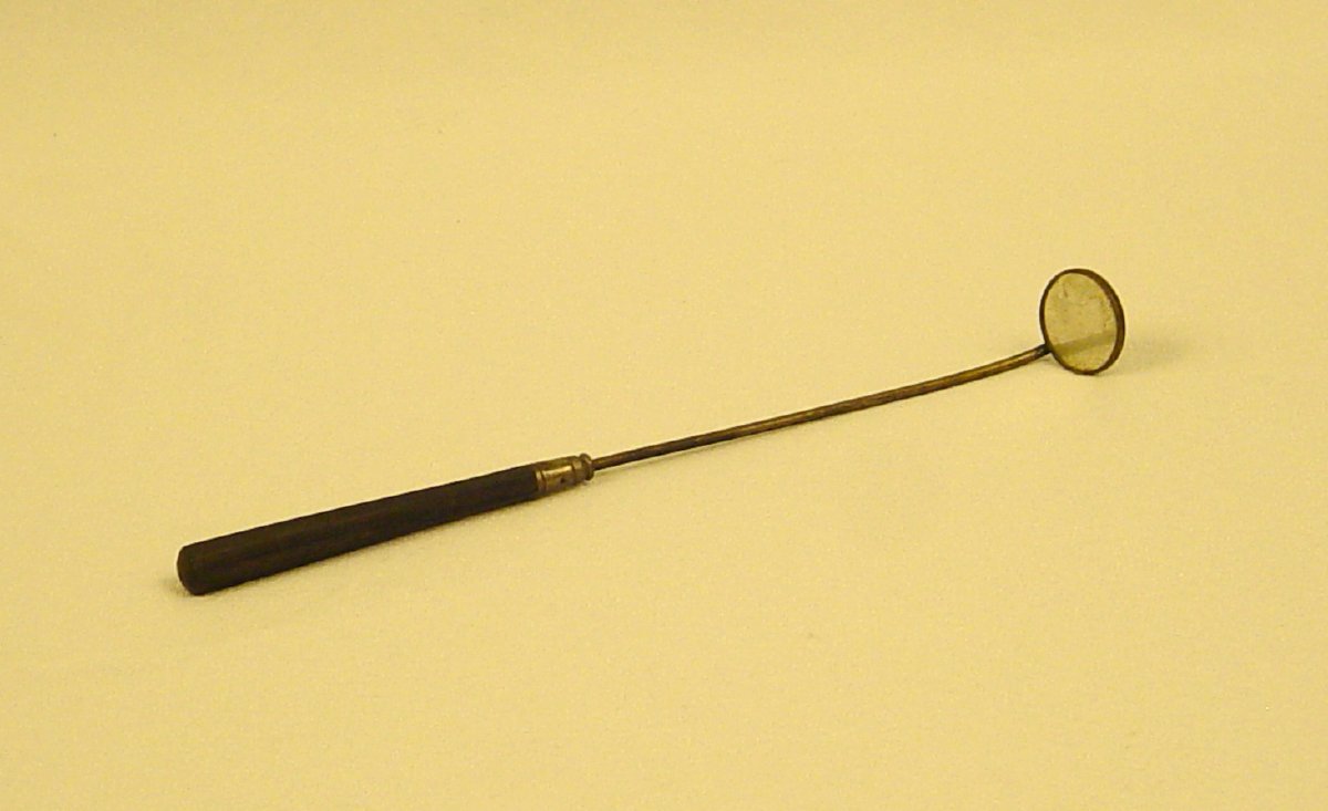 Long stemmed laryngeal mirror with little round mirror on the end.