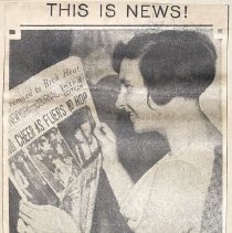 This is news!
Mrs. Harold R. Gatty reads the Evening Journal's account of the arrival of her husband and Wiley Post at the goal of their world flight---Roosevelt Field.