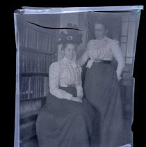 E. Alice Austen, [Nellie & Patty in Study], ca. 1910.