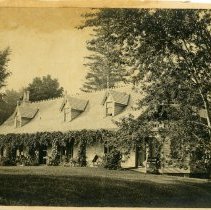 EAA  [John H. Austen in rocking chair on the porch of Clear Comfort], 1885