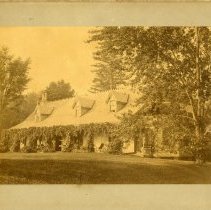 EAA, [John H. Austen in rocking chair on the porch of Clear Comfort], 1885