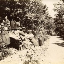 E. Alice Austen, [Group of eight by large rock near road], ca. 1897