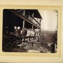 E. Alice Austen, [Group sitting on porch railing], 1899