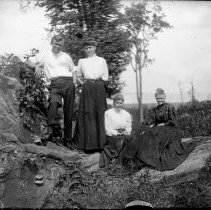 E. Alice Austen, [A group of four on a fallen tree], ca. 1892