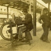 E. Alice Austen, Man grinding knives, 1894.