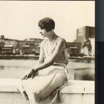 Ffp776 Agnes Woods Sitting On A Wall By Water