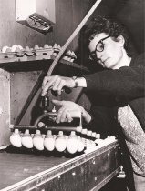 a worker examining eggs at the farm