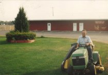 Reid Merrill mowing the lawn, Merrill Egg Farm