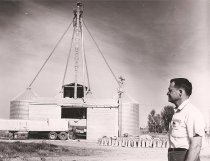 Reid Merrill looking at his modern Feed Mill