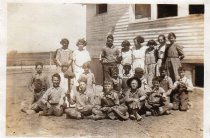 Pleasant View School students posing next to school building