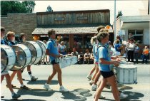 Marching band walks in front of Eagle Library and City Hall 1986