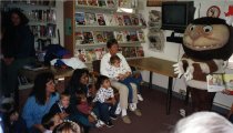 Group listens to a story with a wild thing character