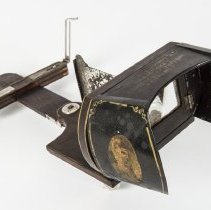 Japanning, pinstriping, and transfer decal on the tin eye shields