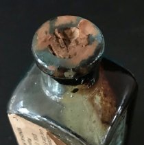 Detail of mouth with cork and paper remnants