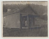 Round Valley Indian Reservation School out-building with a couple people on the porch.
