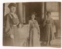 Two Indian girls and a school employee inside a building at the Round Valley Reservation Boarding School.