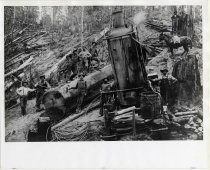 Donkey engine with woods crew and waterbag-packing donkey.