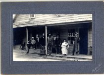Group posed in front of store/saloon/post office in Melbourne.