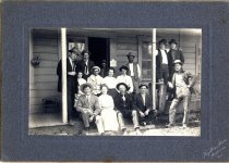 Group portrait on porch of post office/saloon/store, Melbourne.