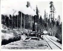 Donkey engine with crew at railroad loading area.
