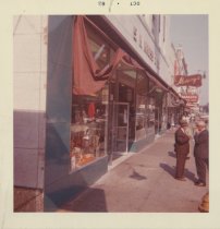 Color photograph of the Kress store main entrance. Window displays and cust