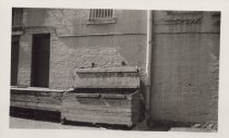 Black and white photograph of Kress back alley with a dumpster visible