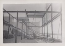 Black and white photograph of Kress construction site with frame being inst