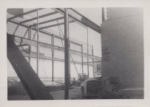 Black and white photograph of Kress construction site with frame being inst
