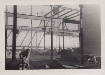 Black and white photograph of Kress construction site with frame being inst