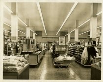 Black and white photo of interior women's beauty and clothing sales area, t