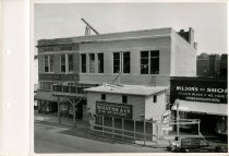 Black and white photograph of construction of second story addition, taken