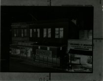 Black and white negative of construction of second story addition, taken in