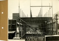 Black and white photograph of girder skeleton rear view during construction