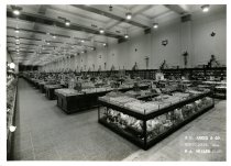 Black and white photographic print of interior sales area with ceramic anim