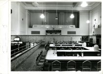 Black and white photograph of interior restaurant dining counters, received