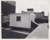 Black and white photograph of rooftop supply ducts