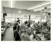 Black and white photograph depicting interior sales area, taken in April 19