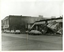 Black and white photograph depicting exterior fire damage, taken in January