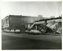 Black and white photograph depicting exterior fire damage, taken in January