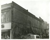 Black and white photograph depicting exterior fire damage, taken in January