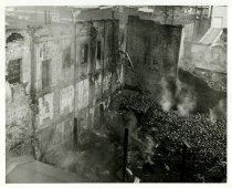 Black and white photograph depicting exterior fire damage, taken in January