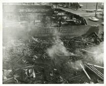 Black and white photograph depicting exterior fire damage, taken in January